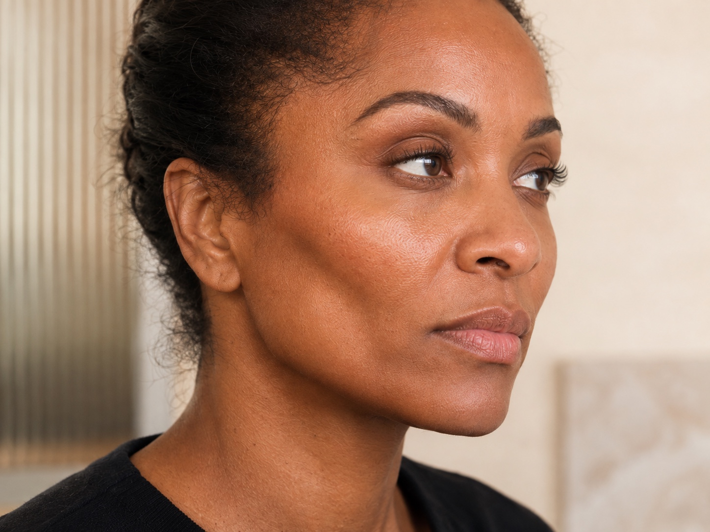 Woman viewed in three-quarter profile during a cheek and facial balance assessment