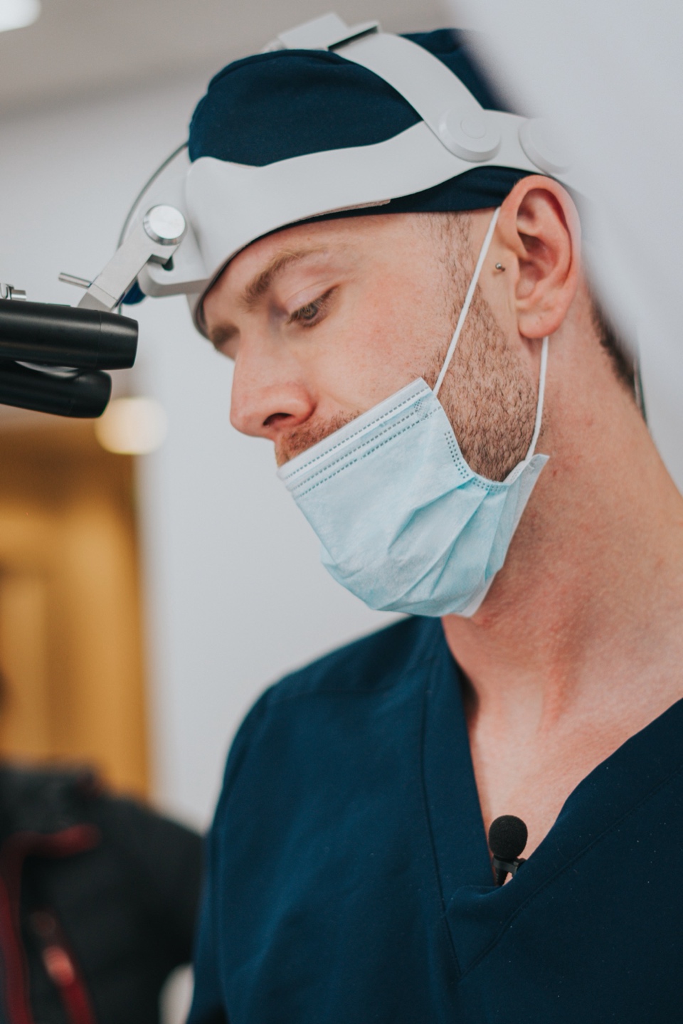 Dr Jamie Harrison wearing surgical magnification and a mask at the Bury clinic
